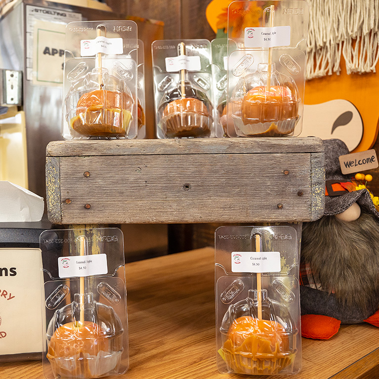 A display of caramel apples in packaging ready for purchase.