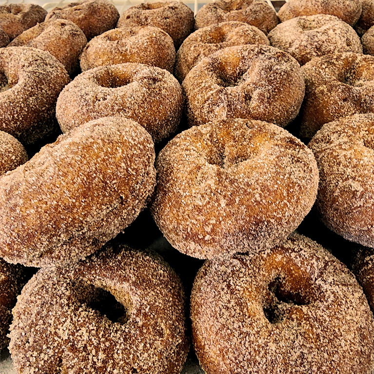 A tray of fresh apple cider donuts